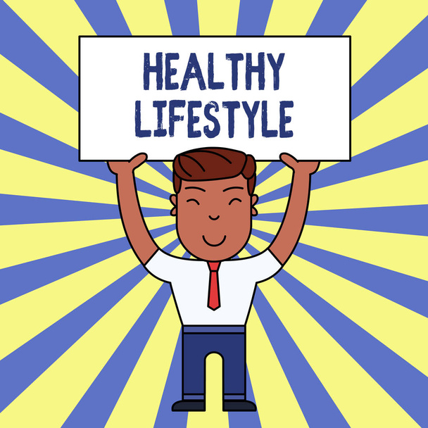 Handwriting text writing Healthy Lifestyle. Concept meaning Live Healthy Engage in physical activity and exercise Smiling Man Standing Holding Big Empty Placard Overhead with Both Hands. - 写真・画像