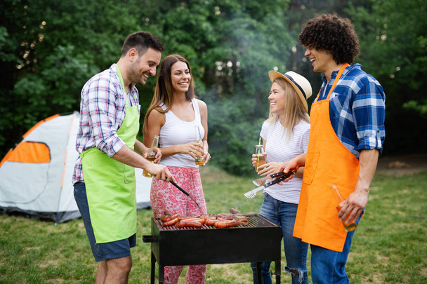 Group of friends having a barbecue party in nature - Foto, Bild