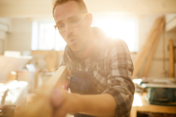 Waist up portrait of skilled modern carpenter working in sunlight, copy space - Photo, Image