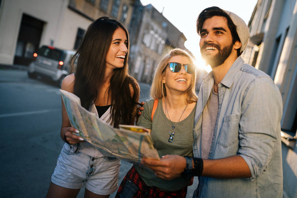 Friendship, travel, vacation, summer and people concept. Group of smiling friends traveling - 写真・画像