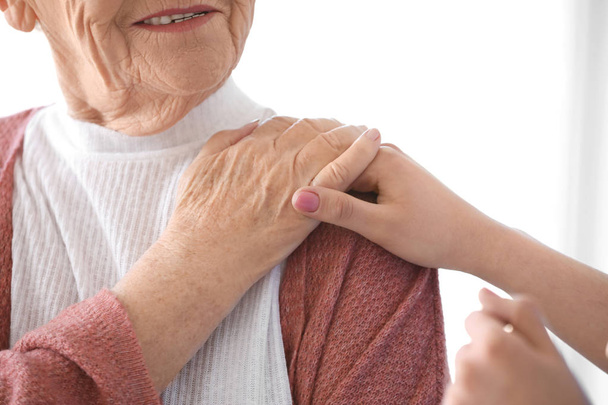 Caregiver with senior woman in nursing home, closeup - Фото, зображення