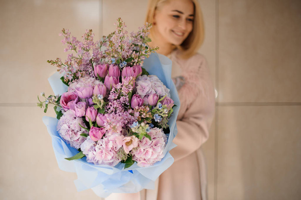 Girl holds bouquet of peonies, roses and lilac - Photo, Image