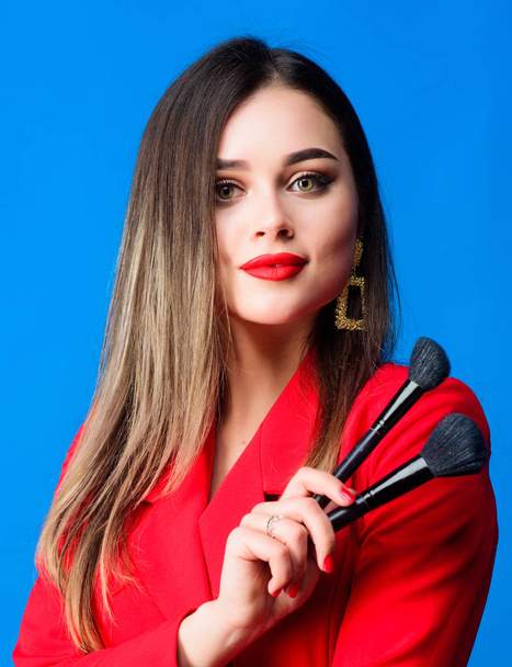 Looking good and feeling confident. Gorgeous lady makeup red lips. Attractive woman applying makeup brush. Strengthen confidence with bright makeup. Perfect skin tone. Makeup artist concept - Zdjęcie, obraz