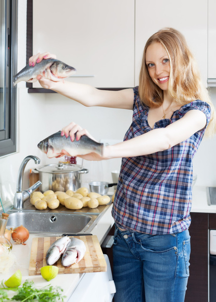 Smiling blonde woman with seabass fish - Foto, immagini