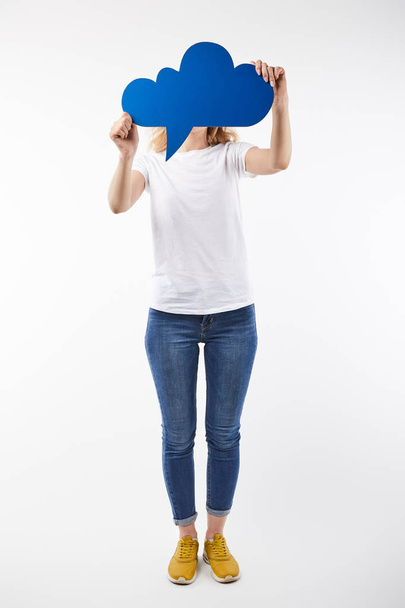 woman with blue thought bubble in hands standing isolated on white - Foto, afbeelding