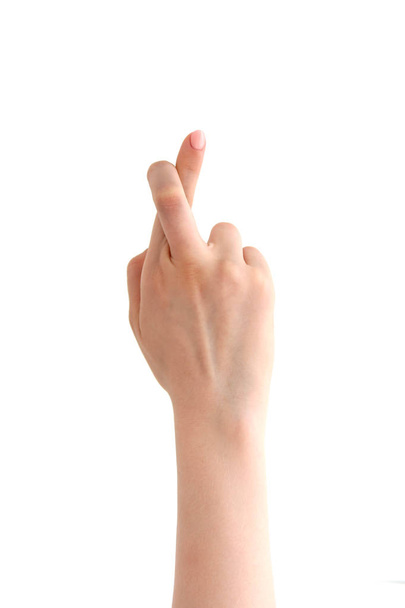mão com dedos cruzados no fundo branco
 - Foto, Imagem