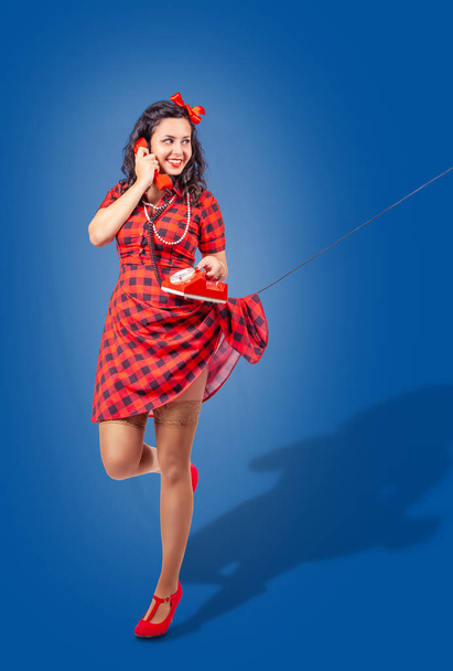 happy young pinup standing woman talking on phone - Photo, Image