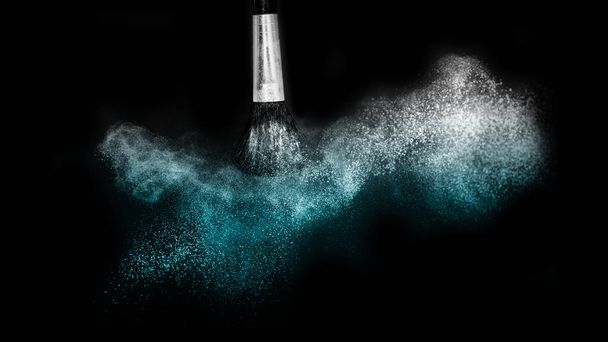 Cosmetic brush with blue cosmetic powder spreading for makeup ar - Photo, Image