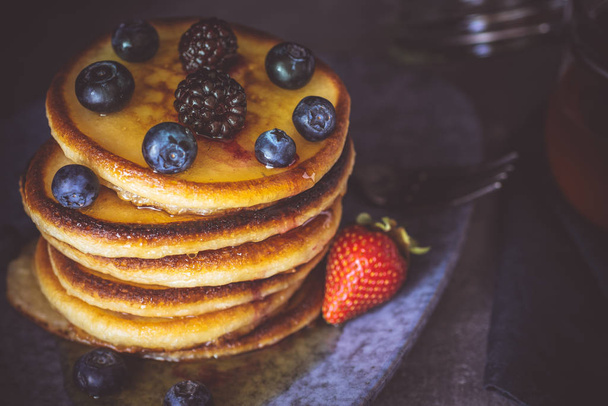 Fresh Pancakes with Organic Maple Syrup and Berries on Dark Background - Photo, Image