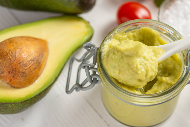 Vegan Raw and Healthy Fresh Food Concept. Organic Green Avocado Spread Guacamole in Jar. - Photo, Image