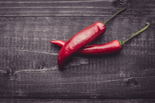 Red Hot Chili Peppers on Dark Rustic Wood Background - Fotografie, Obrázek