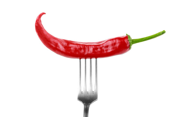 one red hot chilli pepper or jalapeno on fork isolated on white background, spicy food concept - Photo, Image