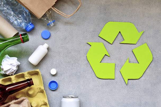 Recycling symbol and different garbage on gray background. Top view. - Photo, Image