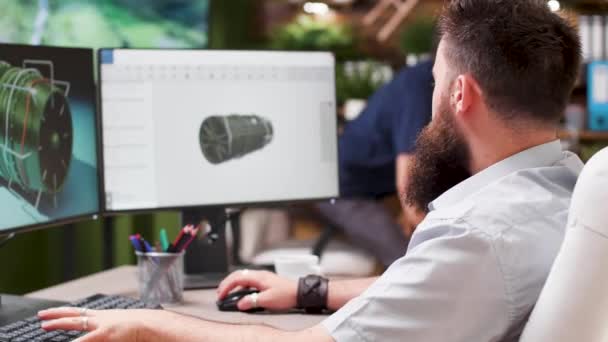 Bearded hipster architect works on 3D model of a turbine - Footage, Video