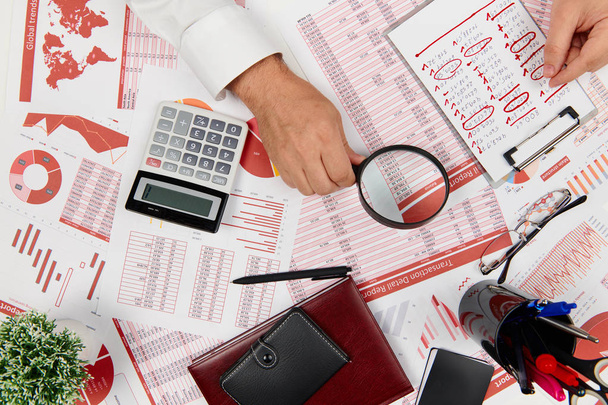 Flat top view of businessman working and calculating finance, reads and writes reports. Business financial accounting concept. - Photo, Image