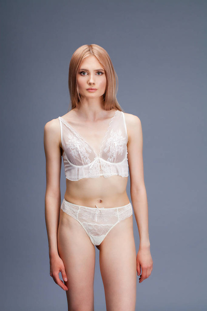 Sexy young blonde woman posing in white underwear  - Foto, Bild