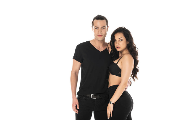 couple in black clothes embracing and looking at camera isolated on white - Foto, afbeelding