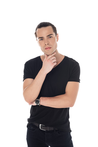 front view of pensive young man in black t-shirt looking at camera isolated on white - Fotografie, Obrázek