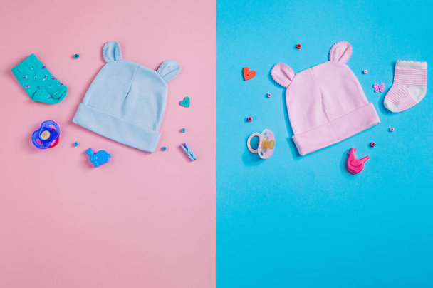 Funny baby's caps with ears over pink and blue background - Foto, Imagen