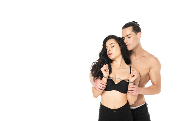 sexy couple with handcuffs embracing isolated on white - Φωτογραφία, εικόνα