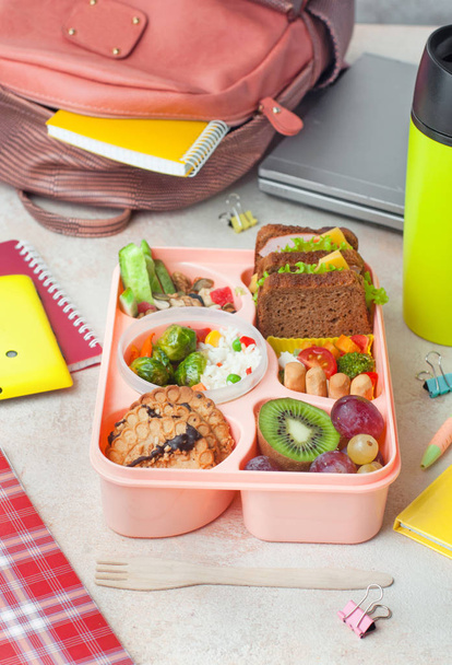 Lunch box with sandwiches, vegetable salad and fresh fruits and  - Photo, Image