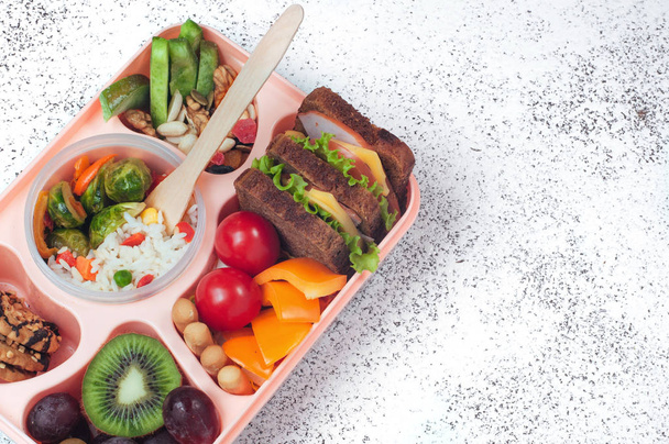 Open lunch box with healthy lunch on grey background with copy s - Photo, Image