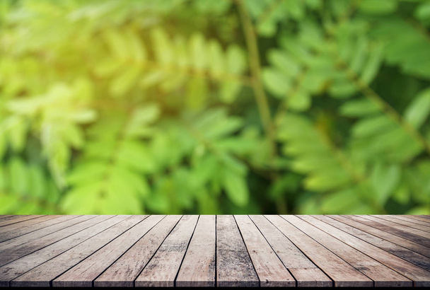 Wood planks with abstract natural green blurred bokeh background for product display - Foto, imagen