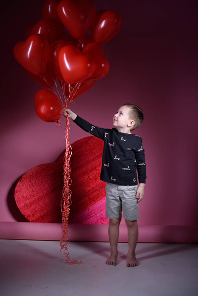 Valentine's day holiday. Boy on Valentine's Day with balls. - Фото, изображение