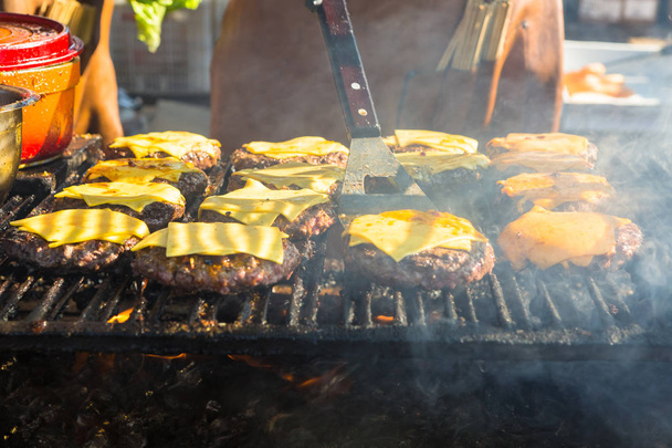 Hamburger being grilled over a wood fire - Foto, imagen