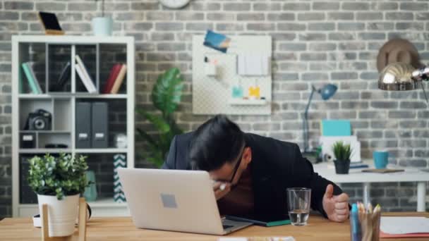 Unhealthy guy employee sneezing wiping nose then drinking water in office - Felvétel, videó