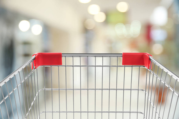 Empty shopping basket on blurred background, closeup - Фото, изображение
