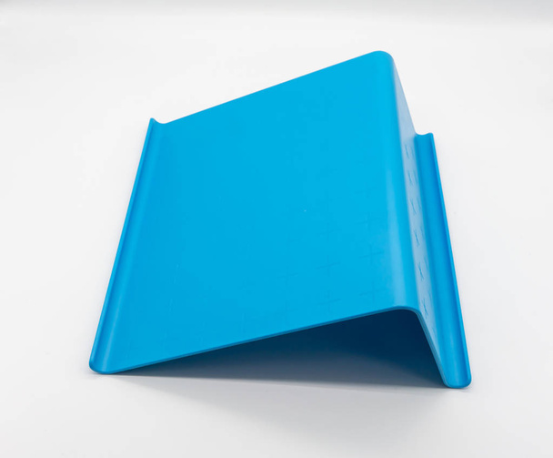 White digital tablet on blue plastic tablet stand isolated on wh - Photo, Image