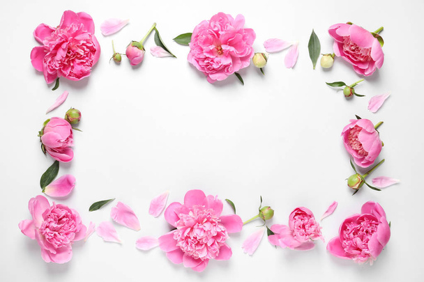 Frame made with fresh peonies on white background, top view. Space for text - Photo, Image
