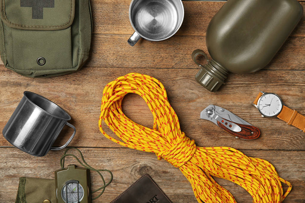 Flat lay composition with camping equipment on wooden background - Valokuva, kuva