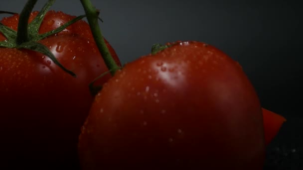 Close-up rotation red tomatoes covered by drops of water. Fresh and juicy, perfect for diets. 4K resolution, loop video. - Záběry, video