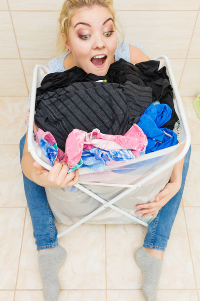Woman with big basket of dirty clothes laundry. - Foto, imagen