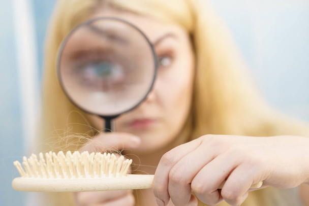 Woman magnifying hair brush - Photo, Image