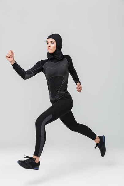 Woman fitness muslim doing exercise isolated over white wall background - Foto, Imagem