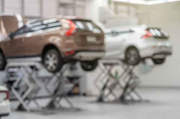 Abstract photo blurred of Car lift in automobile service or maintainance service center which is a part of showroom,  technician or professional work for customer concept - Zdjęcie, obraz