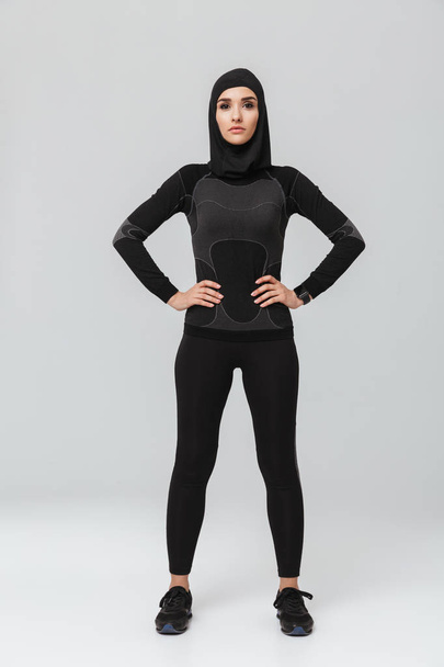 Young woman fitness muslim posing isolated over white wall background. - Valokuva, kuva