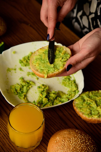 Making avocado toast on the home kitchen - Foto, imagen