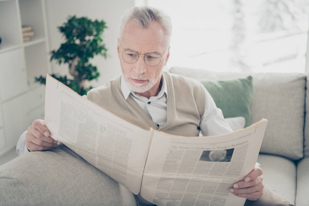 Close up photo amazing he him his aged man arms hands fresh press newspaper political media wear specs white shirt waistcoat pants sit cosy comfort bright flat house living room indoors - Photo, Image