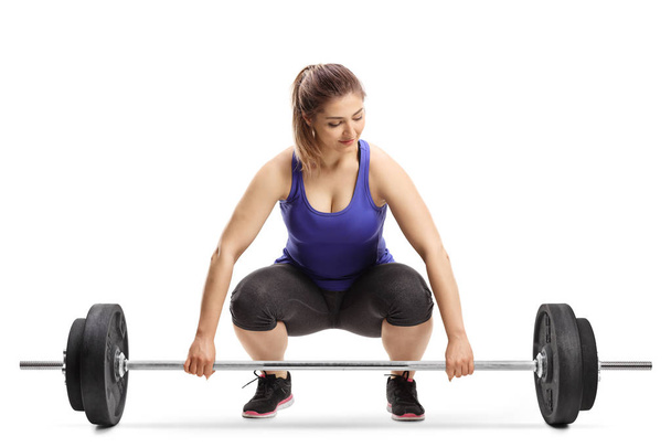 Young woman preparing to lift weights isolated on white background - Photo, Image
