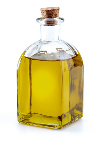 Natives Olivenöl extra in Glasflasche. Im Vordergrund. umfasst Blätter und Olivenzweige. isoliert auf weißem Hintergrund. - Foto, Bild