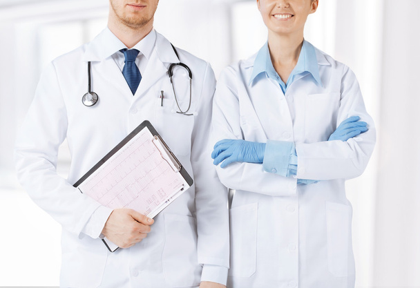 Nurse and male doctor holding cardiogram - Foto, Imagen
