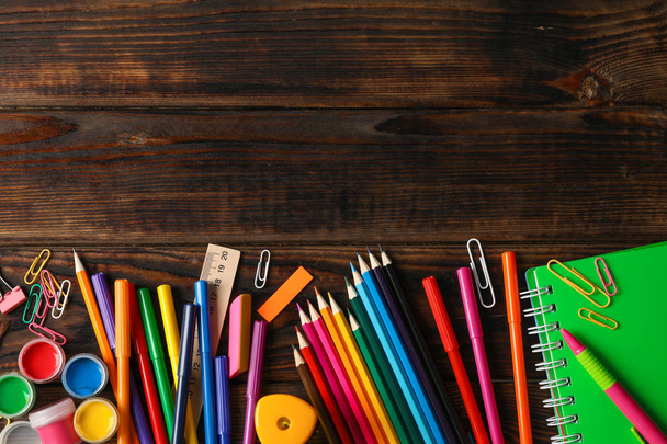 Flat lay composition with school supplies on wooden background,  - Foto, Bild