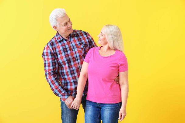 Portrait of happy mature couple on color background - Photo, image