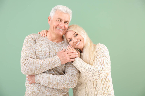 Portrait of happy mature couple on color background - Foto, afbeelding