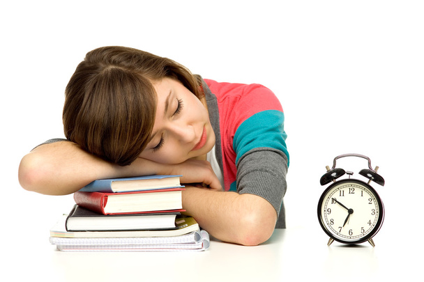 Estudiante durmiendo al lado del despertador
 - Foto, imagen