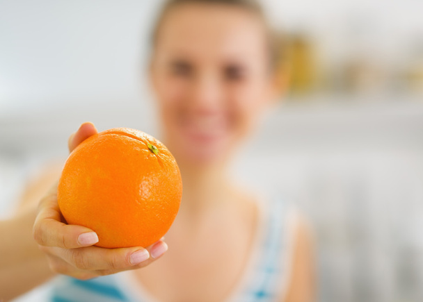 Closeup on orange in hand of young woman - Foto, imagen